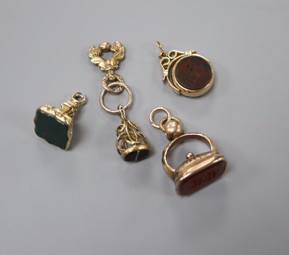 Four assorted 19th century and later yellow metal or gold plated hardstone set fob seal and one odd bale.